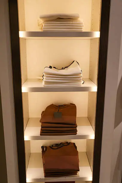 Integrated LED lighting inside a custom walk-in closet with backlit shelving in the DMV area