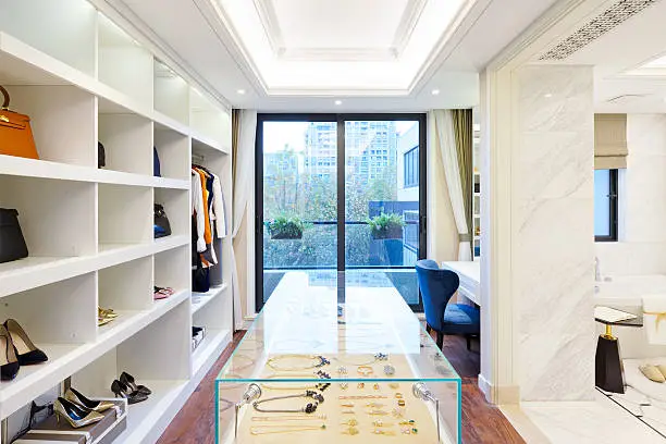 Boutique-style walk-in closet with open shelving, glass cabinets, and a center island in Northern Virginia