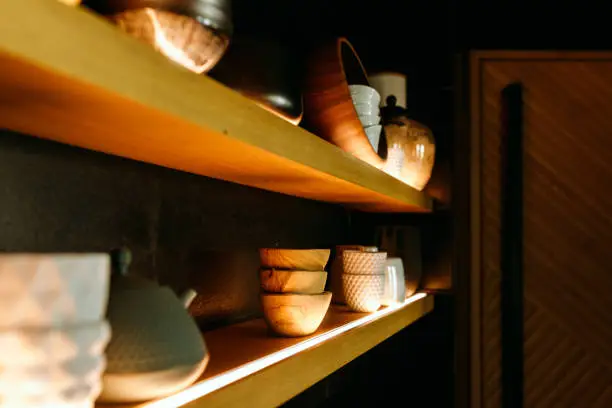 Custom kitchen pantry organization with integrated LED shelf lighting and warm wood shelving in a Northern Virginia luxury home