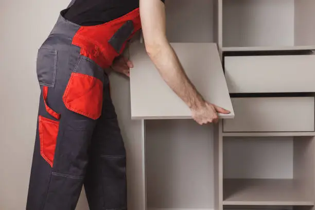 Closet and Design professional installing a custom built-in closet system in a McLean VA home — white-glove installation