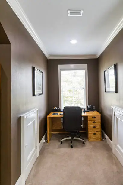 Unused alcove converted into a built-in home office Northern VA with custom desk, overhead cabinetry, and integrated lighting in an Alexandria VA home